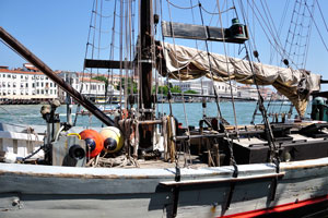 An atypical vessel is docked near Punta della Dogana