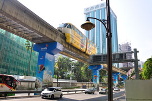 Coupled two-car monorail train drives along Jalan Sultan Ismail