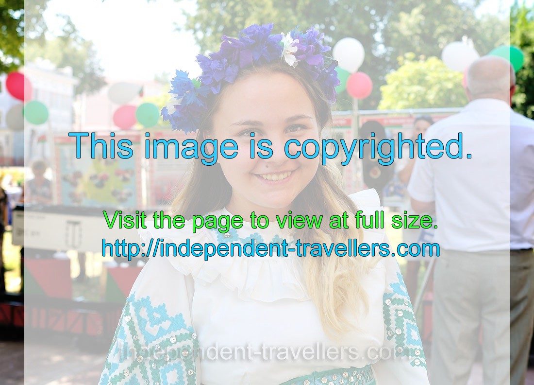 A young Belarusian girl is wearing a blue floral wreath