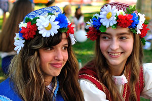 Two good-looking Belarusian young girls wear floral wreaths