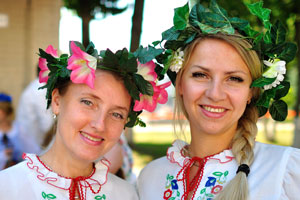 Two beautiful Belarusian women wear floral head wreaths