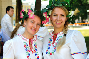 Two attractive Belarusian women wear national dresses