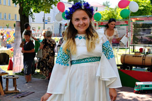 A young Belarusian girl is wearing a national dress of white color