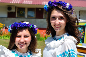 Two charming Belarusian girls are in blue floral head wreaths