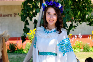 A ravishing Belarusian girl is in a full-length white dress