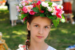 A beautiful little girl wearing a floral head wreath