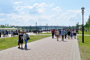 People walk along the seafront of Sozh river