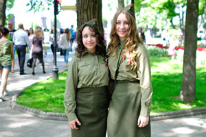 Two beautiful girls are in the military uniform