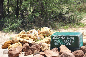 A stone shows the directions to Kgama Drive and Pan's Edge