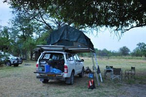 The Toyota Hilux 4x4 is under the tree in Third Bridge Campground
