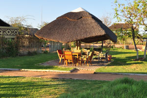 A thatched roof gazebo is in Makumutu Lodge & Campsite