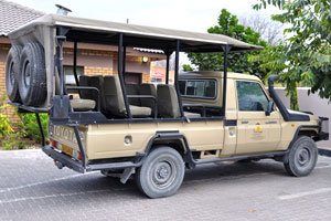 An open-sided Toyota Land Cruiser jeep belongs to Senthaga Guest House and Safaris