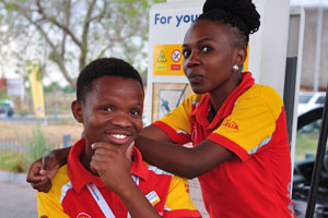 Two young people work at the petrol station
