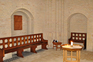 The are benches and church candles inside the church