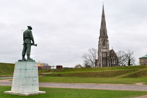The Our fallen (Vore faldne) monument is on the background of St. Alban's Church