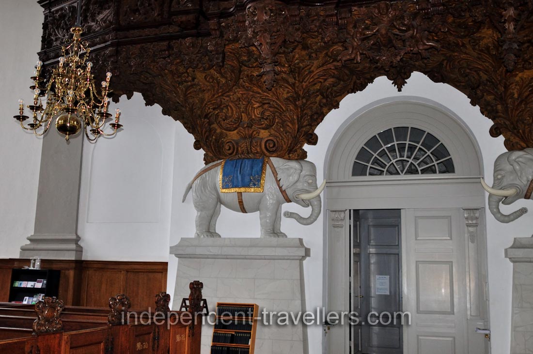 The elephant statues are located below the organ of the Church of Our Saviour