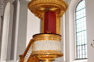 A pulpit at the Church of Our Saviour is equipped with a round golden sounding board