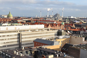 The dome of the Marble Church and the large industrial pipes of Amagerværket power station as seen from the Round Tower