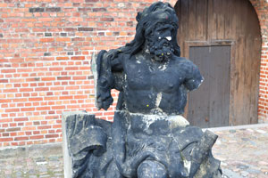 The black statue of Neptune is situated beside the Lapidarium of Kings