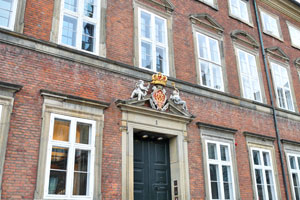 This coat of arms is installed over the door of building at Christiansborg Slotsplads #1