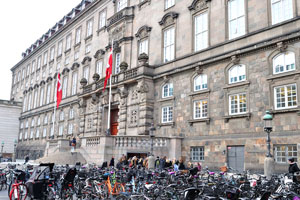 Two state flags of Denmark are installed at the entrance to the Danish Parliament