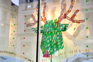 A Christmas shop window display reads: “Had a very shiny nose, and if you ever saw it, you would even say it glows”