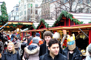 The Christmas market on Højbro Plads square is crowded by people