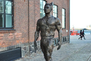 The statue of shipyard's worker decorates the street near the Værftsmuseet museum