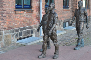 The statues of three shipyard's workers are situated at the entrance to the Værftsmuseet museum