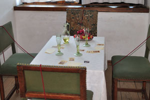 There is a card table with fruits and empty wine glasses in the tower of Kronborg castle