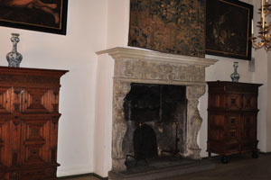 The vintage fireplace in the Little Hall of Kronborg castle is decorated with the tapestry