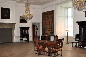 This room of Kronborg castle contains paintings, a tapestry and a fireplace