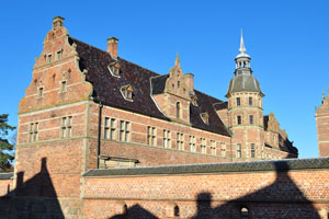 Frederiksborg Castle is built with towering spires and light sandstone decorations