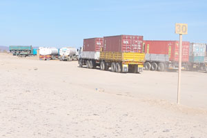 Trucks transporting shipping containers