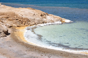 Intense heat and strong winds fuel rapid evaporation, leaving a ring of minerals around the lake's shore