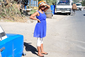 Woman in blue dress near the Yilma hotel on the Lesotho street