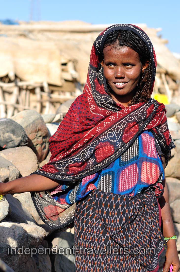 Afar woman shows the sharpened teeth while smiling