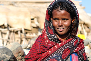 Afar woman shows the sharpened teeth while smiling