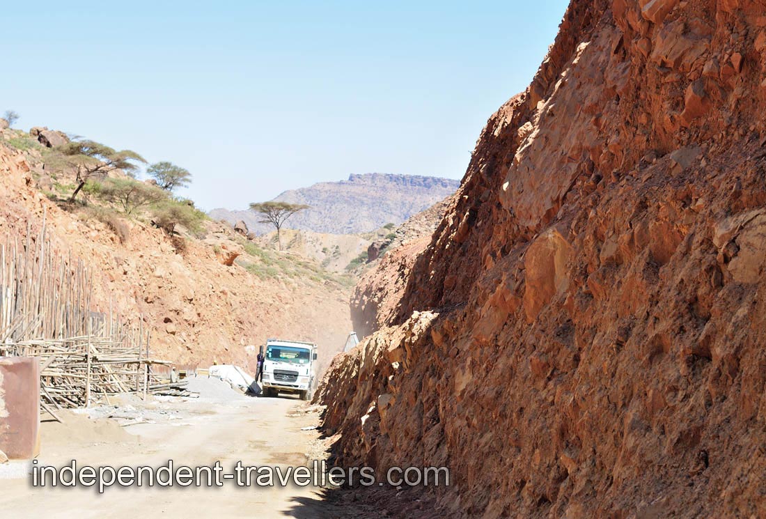 The mountain road is very thin, so we should wait until this car will pass by