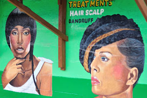 An inscription on the wall reads: “Treatments hair scalp dandruff”