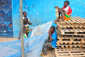 Young boys are repairing a fishing net