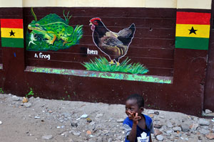 A frog and a hen are painted on the wall of school