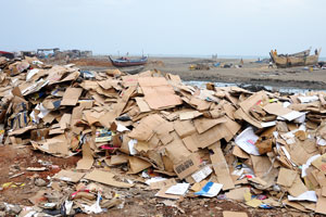 There are piles of cardboard in the slums