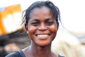 A beautiful girl which lives in the slums smiles to me