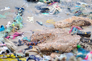 Garbage is on the shore of the Gulf of Guinea in the fisherman's village
