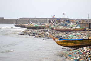 Boats are on the shore of the Gulf of Guinea in the fisherman's village