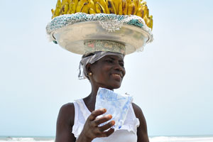 A female vendor of bananas is smiling