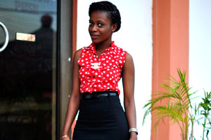 A stunning Ghanaian lady is dressed in the red blouse
