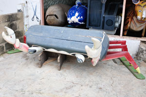 A coffin in the shape of a colourful crab is in the Kane Kwei Carpentry Workshop