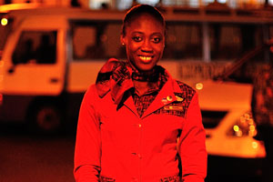 A flight attendant dressed in red coat is in Kotoka International Airport
